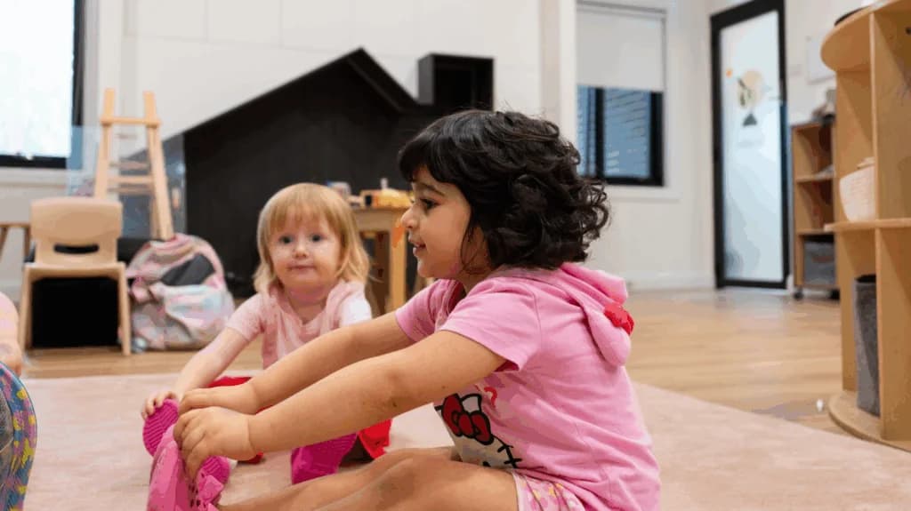 Two children sitting together and engaging in collaborative play at Simba Education