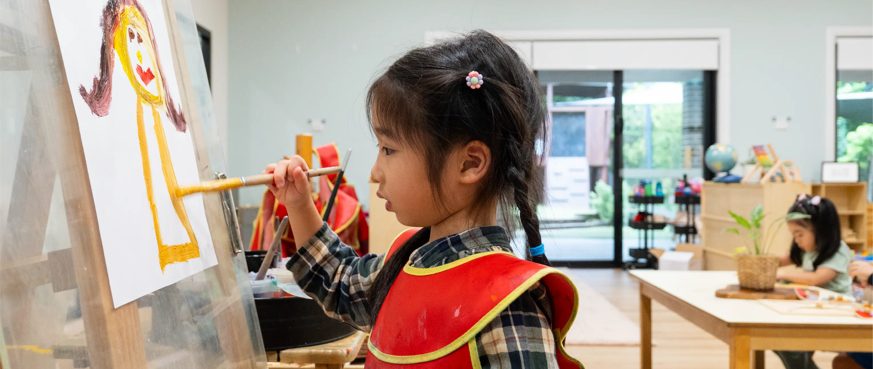 Educator documenting a child’s learning journey through shared observations and reflection