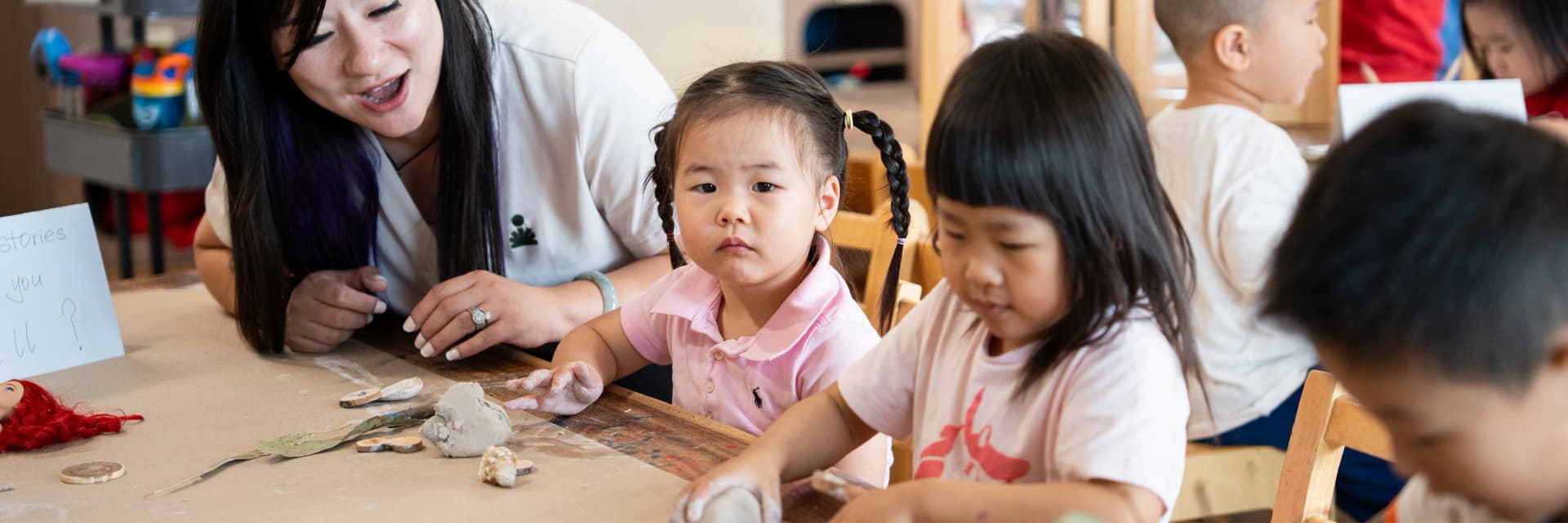 Educator and children exploring clay and natural materials at a Simba Education early learning centre in Sydney